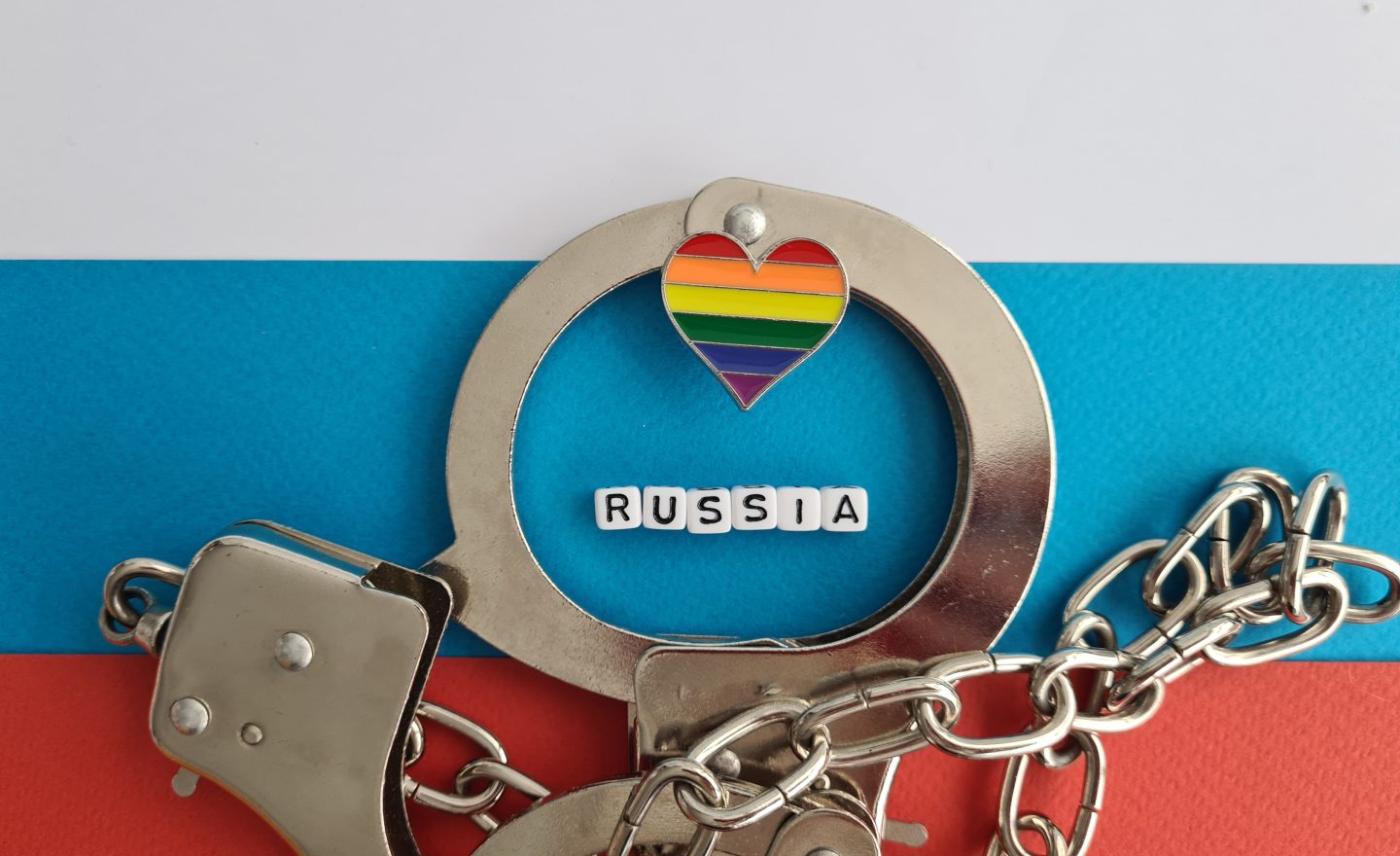 Ban Russia and rainbow flag and handcuffs. LGBT conflict and rights concept