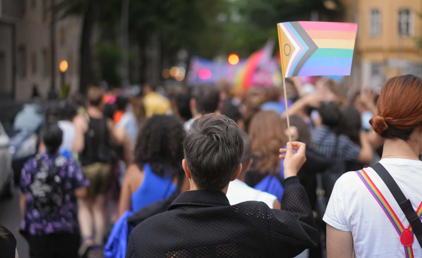Lesbian woman enjoy lgbt pride month. Girl waving rainbow flag. Gay community.
