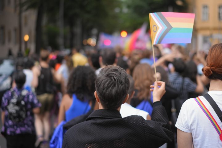 Lesbian woman enjoy lgbt pride month. Girl waving rainbow flag. Gay community.
